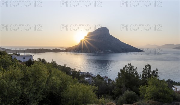 Sunshine over sea and hills in evening mood