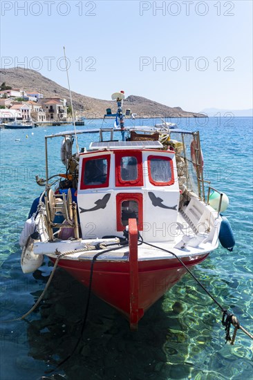 Fishing boat in Halki harbour with turquoise blue water