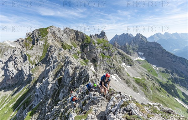 Mountaineer on a ridge on a secured via ferrata