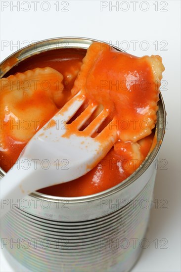 Ravioli in tin and plastic fork