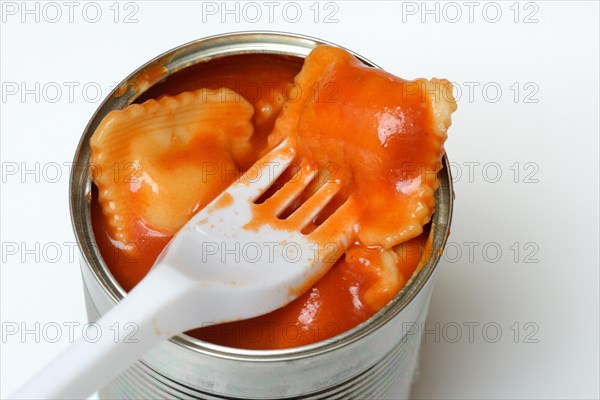 Ravioli in tin and plastic fork