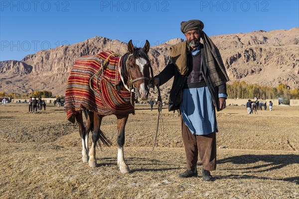 Old man with his horse at a Buzkashi game