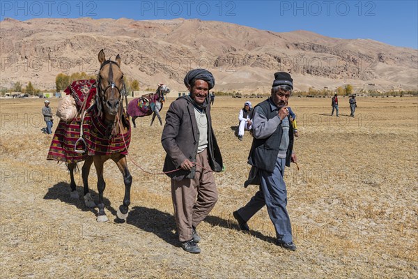 Old men with their horses at a Buzkashi game