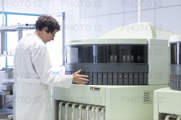 Technician processing samples with laboratory equipment in a histology laboratory