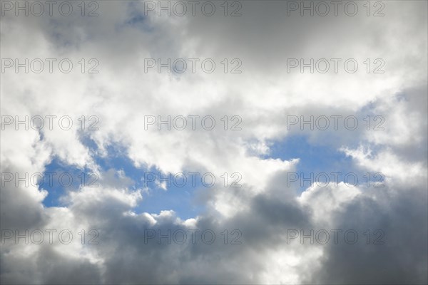 Stratocumulus clouds and blue sky windows form spectacular cloud formation in the sky during Foehn storm