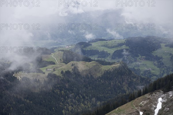 Fog and clouds drifting over landscape