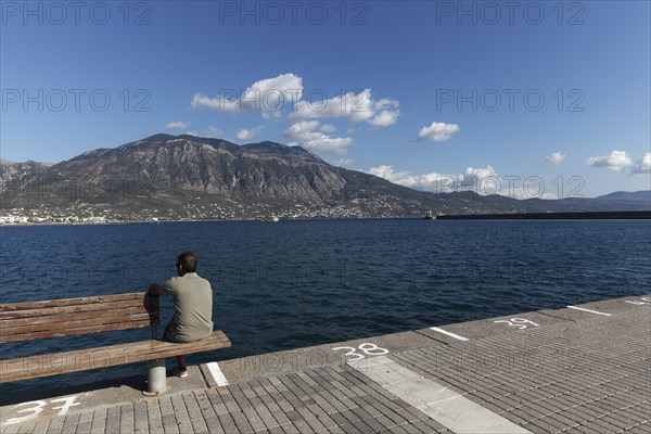 Man sitting on a bench at the pier