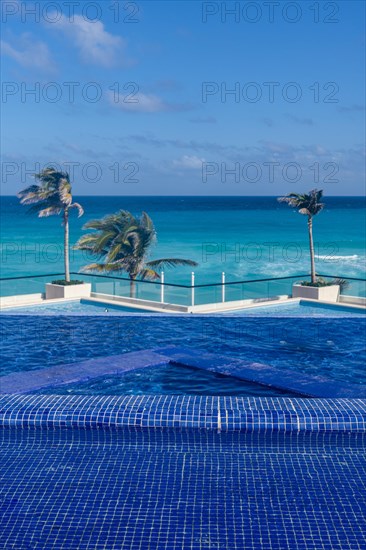 Swimming pool over the turquoise waters of Cancun