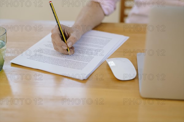 Woman proofreading at her desk