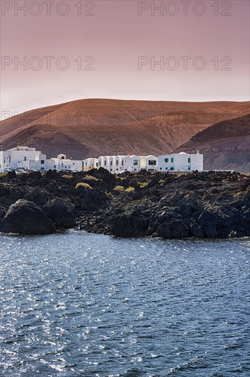 White houses on rocky lava coast