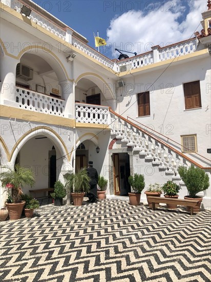 Greek Orthodox clergyman in the courtyard of a monastery