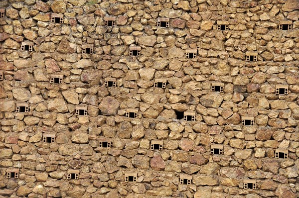 Natural stone wall of a mine with ventilation holes