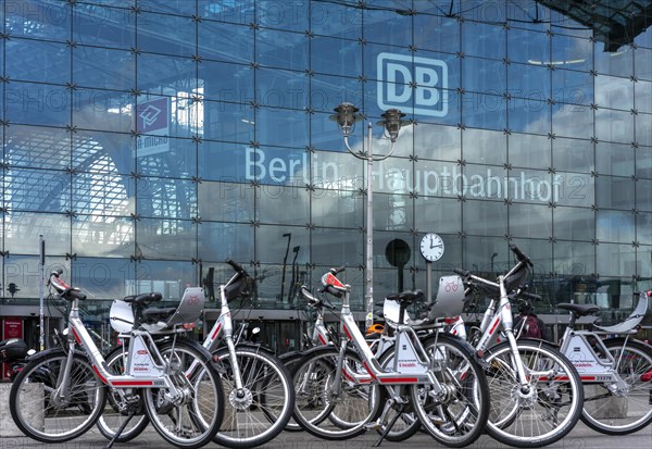 Parked rental bikes in front of the entrance to the main station