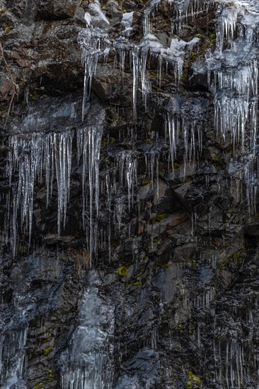 Icicles forming an icefall in the mountain in winter. France