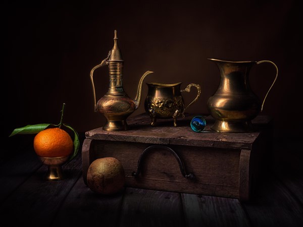 Still life with oriental vessels and glass ball on wooden box