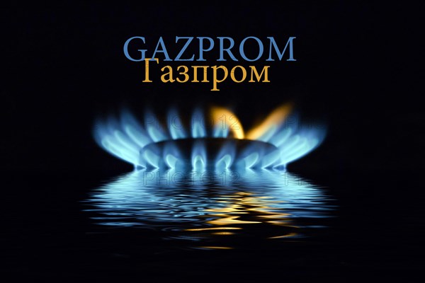 Gas flame with Gazprom logo reflected in the water
