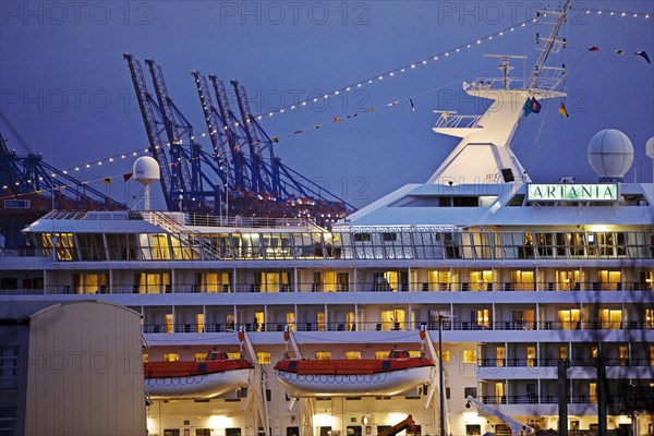 Cruise ship Artania at Hamburg Cruise Center Altona with the cranes of the harbour in the background