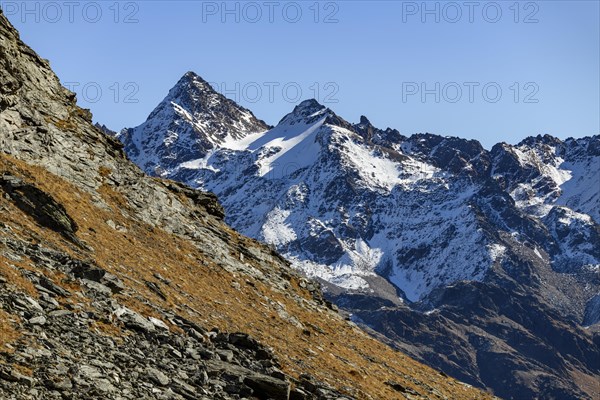 Snow-covered mountain peaks with autumnal landscape