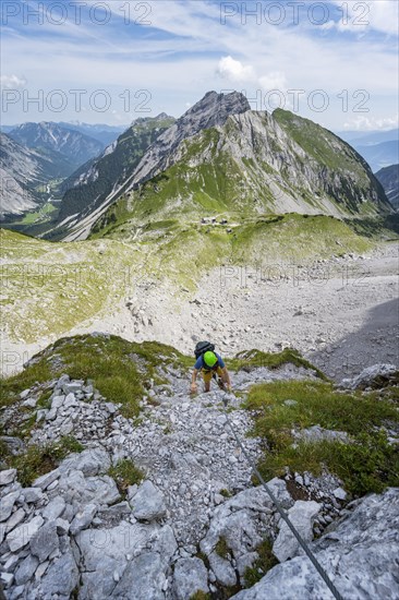 Young man climbing in via ferrata