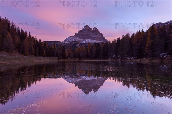 Antorno lake towards Tre Cime di Lavaredo mountain at dawn reflected in lake