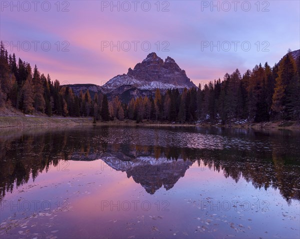 Antorno lake towards Tre Cime di Lavaredo mountain at dawn reflected in lake