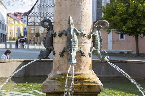 Dragon figures spit water in the market fountain on the market square