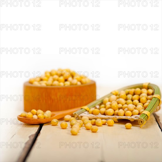 Organic soya beans over rustic wood table macro closeup