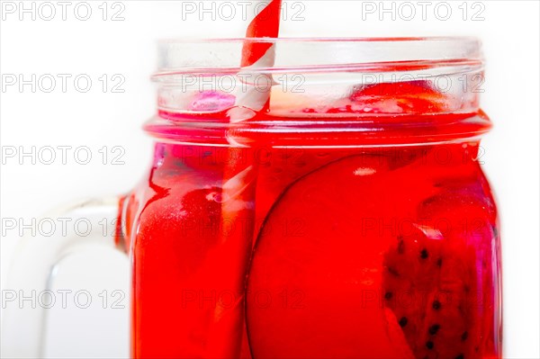 Fresh fruit punch refreshing summer drink over white rustic wood table