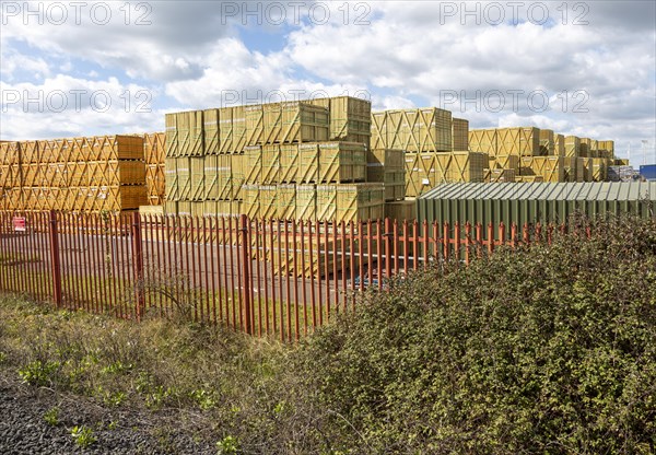 Stacks of wooden fence panels piled up awaiting distribution