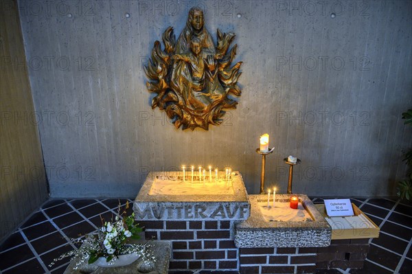 Relief of the Virgin Mary with Christ Child and sacrificial candles