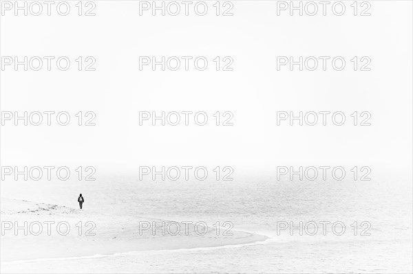 Single person on the shore of the North Sea