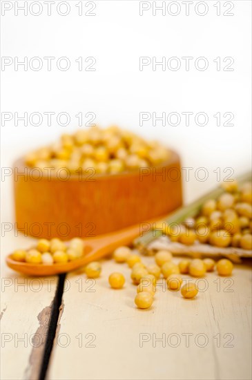 Organic soya beans over rustic wood table macro closeup