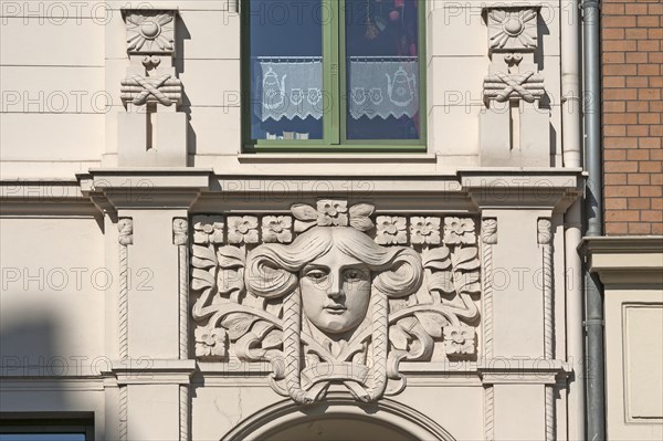 Art Nouveau ornament above a restored entrance to a town house
