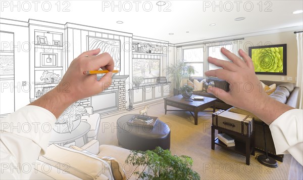 Male hands drawing custom living room design gradating into photograph