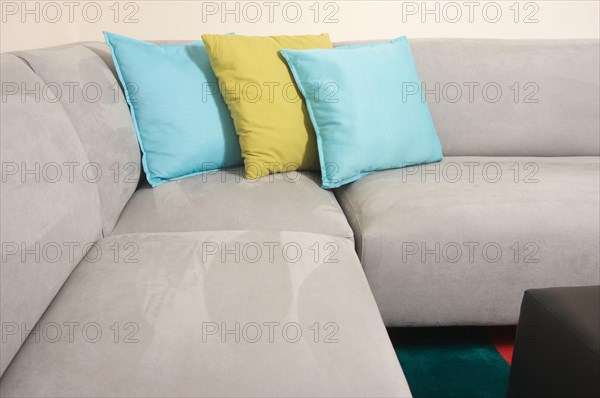 Abstract of grey suede couch & pillows