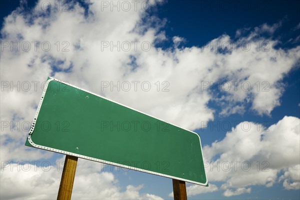 Blank road sign with dramatic clouds and sky ready for your own copy