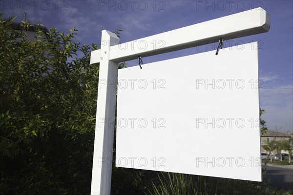 Blank real estate sign in neighborhood ready for your own message