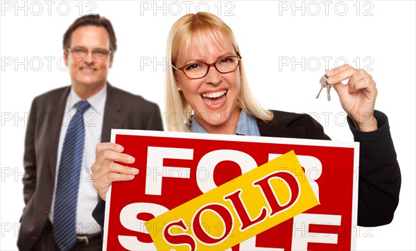 Man behind with attractive blonde in front holding keys and sold for sale sign isolated on a white background