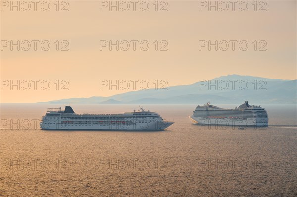 Cruise ships in Aegean sea on sunset. Mykonos island
