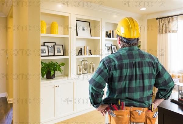 Contractor facing custom built-in shelves and cabinets wall