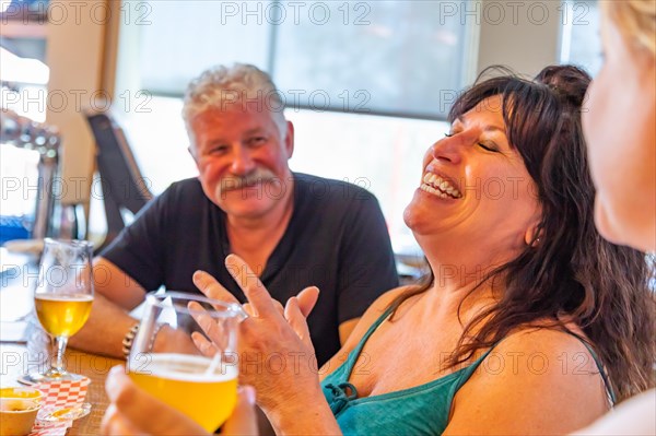 Group of friends enjoying glasses of micro brew beer at bar