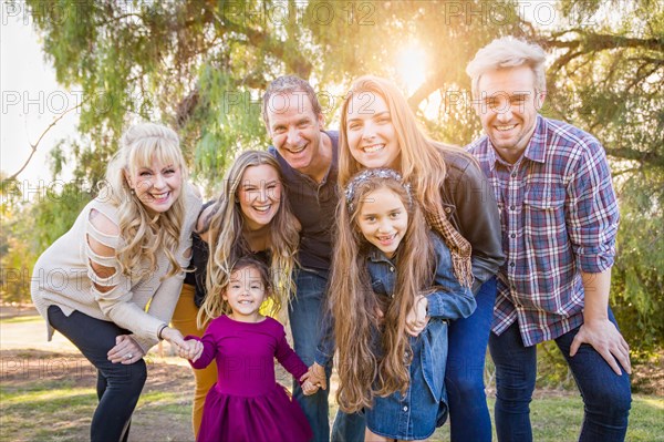 Multigenerational mixed-race family portrait outdoors