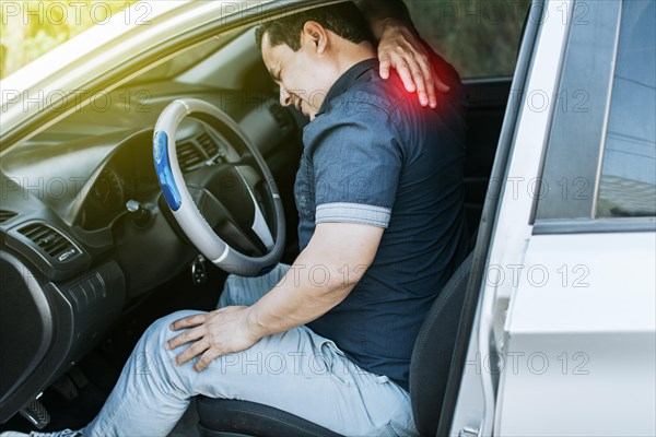 A car driver with muscle pain