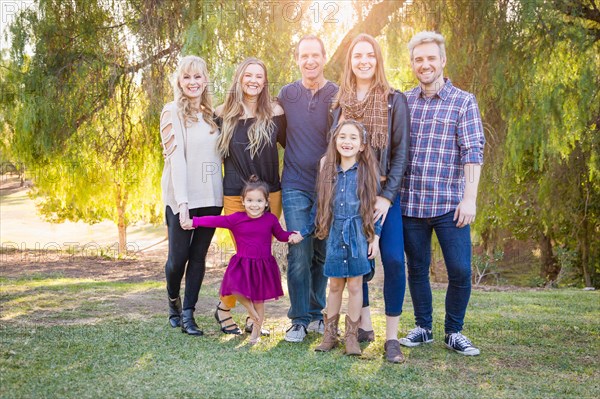 Multigenerational mixed-race family portrait outdoors