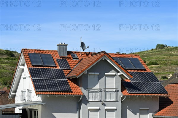 Single-family house with thermal solar system for hot water and solar panels for electricity generation on the roof