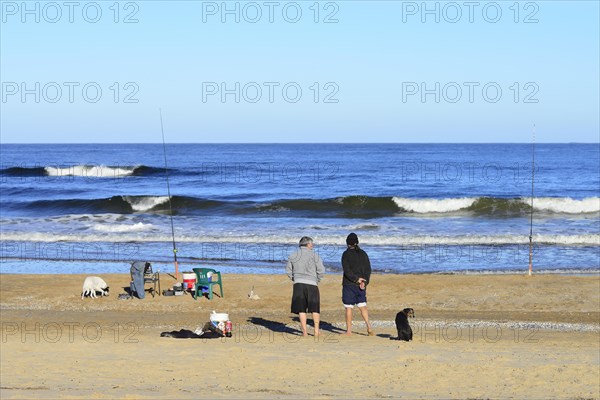 Two anglers on the beach Playa Brava
