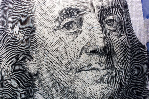 Close up of Benjamin Franklin face on 100 US dollar bill