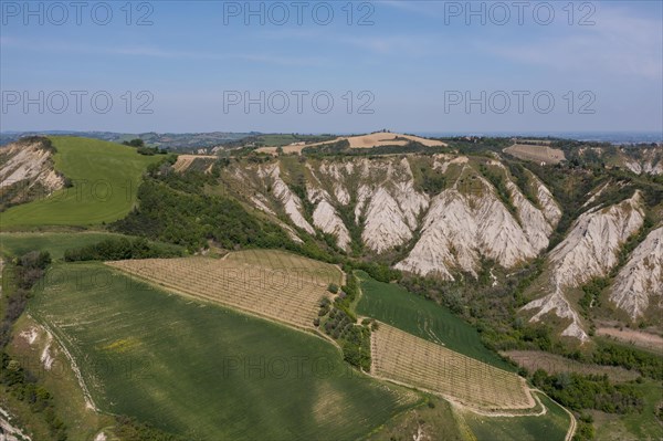 Aerial view of a hilly landscape with erosion valleys