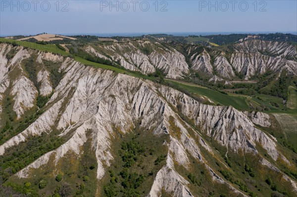 Aerial view of a hilly landscape with erosion valleys