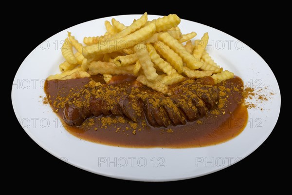 Currywurts with fries on a black background